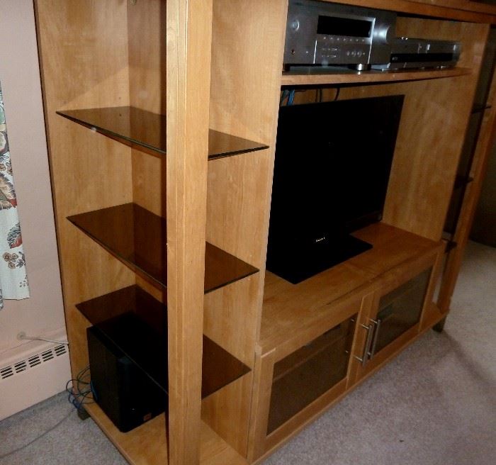 Modern entertainment, storage, display unit.  Solid wood, smoked glass shelves on each side, large opening for flat screen TV, double door storage area, shelf for components ... nice!