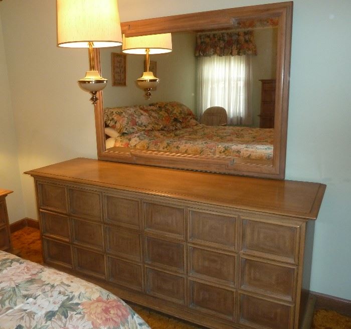 Solid wood Thomasville triple dresser with nine drawers and matching mirror.
