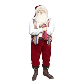 Life Sized Clay Santa Figure by Dee Cash: A life size clay Santa. This piece is dressed in authentic clothing depicting Santa in a home setting with loaded pockets and a Dee Cash tag. This piece is created by Real World Santas by artist Dee Cash.