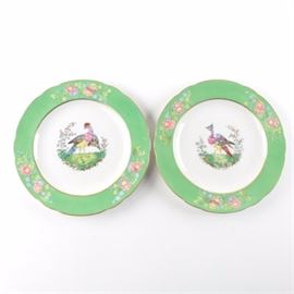 Copeland Spode English Plates: A pair of English Spode plates from Copeland. Both of these plates have gilt exterior and interior edges with green and floral trim between. Along the center of either is a bird depiction, and to the underside are marks that bring both from England and Spode.