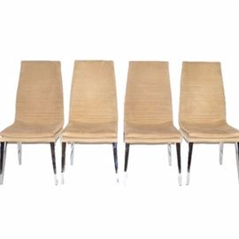 Four Modern Style Suede Chairs by Smania: A collection of four Modern style suede dining chairs by Smania of Venice, Italy. Each chair is covered in tan suede and rises up on four tapering metal legs. The manufacturer’s logo is patterned to the underside of each chair.