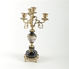 Sevres-Style Hand-Painted Porcelain and Metal Candelabra: A Sevres-style porcelain and metal candelabra. This rococo-inspired piece features four sconces in cast bronze-tone metal. Lower portions of the piece are made of dark blue porcelain featuring an eigthteenth-century courtship scene and hand-painted flowers, scrolling acanthus, and other pictorial embellishments. The piece rests on a round, footed metal pedestal. It is marked on the side “A.C.F. Décor de Sévres.”