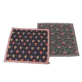 Tapestry Covers: A selection of tapestry covers. The selection includes two covers that are linen and feature a cover with a black finish and a red, green, blue and white needlepoint and embroidered floral design with a geometric border outlined with gold tone stitching and a burgundy backing. Other features of the set are a black cover with a gilded diamond outline that displays an array of balloons in red, gold, blue and green with a red border accented with a gray and gold scroll work design and black cloth backing.
