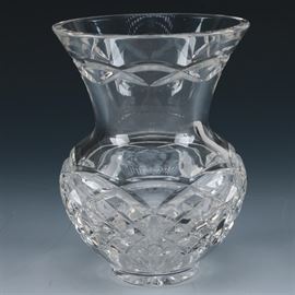 Waterford Crystal Kieran Vase: A Waterford crystal Kieran vase. This lead crystal vase features a flared rim, tapered body and rounded base in Kieran pattern featuring garland and cross cut accents. Vase is marked to the base.