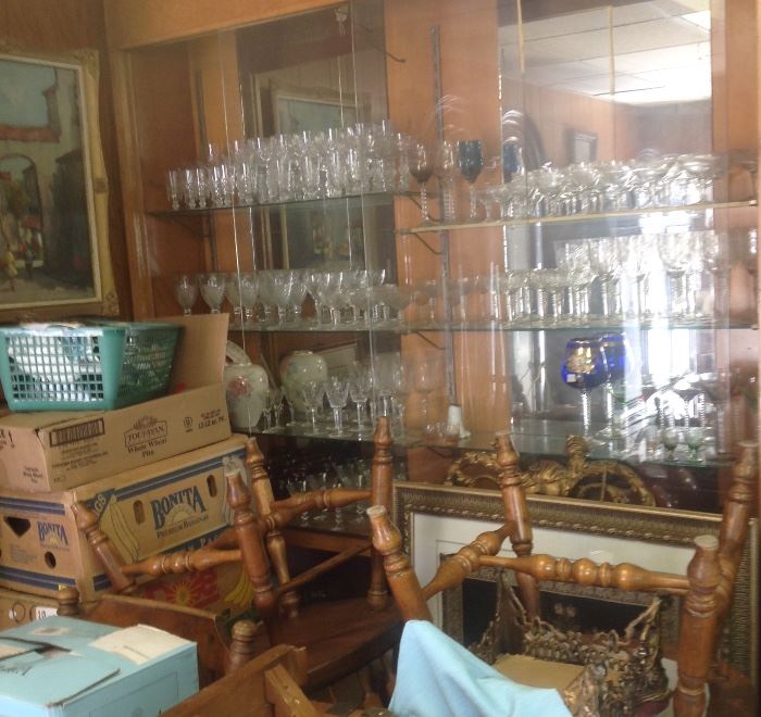 Loads of crystal stemware, Country Windsor chairs, European village scene, oil on canvas