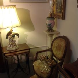 Onyx pedestal, porcelain bird lamp, Victorian oil lamp, French needlepoint chair, gilt metal and crystal sconces