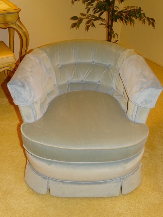 One of two blue barrel-style swivel chairs.