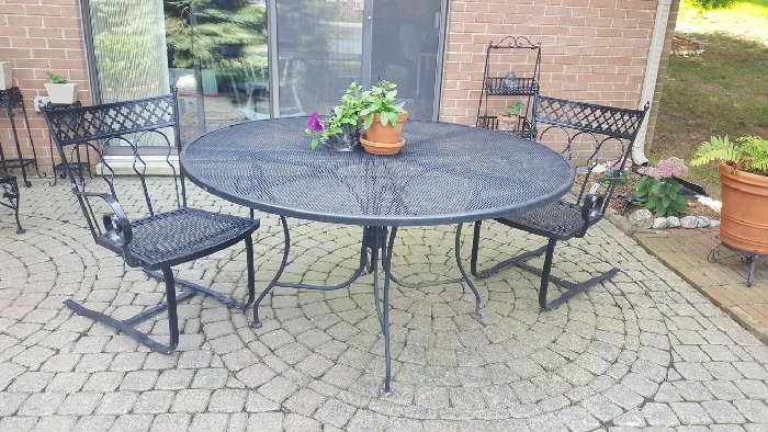 Black wrought iron table  48" with two rocker chairs $125