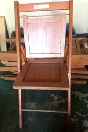 Two sets of four wooden folding chairs