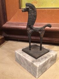 Small modern 'horse' sculpture on grey marble