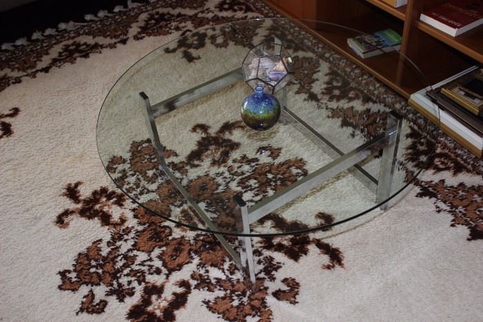 Glass coffee table on rug.