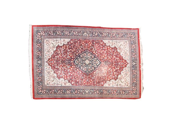 Persian Rug: A Persian area rug. This wool rug features an all over floral, foliate and vine pattern, with fringe ends, and hues of orange, cream, rust and more.