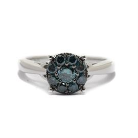 10K White Gold Blue Diamond Cluster Ring: A 10K white gold blue diamond ring. This ring features a prong set blue diamond cluster in a fancy gallery setting with pierced heart motifs.