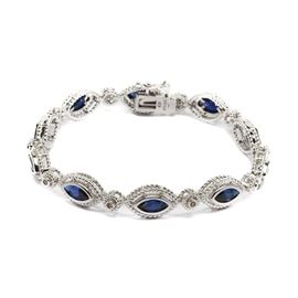 Sterling Silver Sapphire and Diamond Link Bracelet: A sterling silver sapphire and diamond link bracelet. This bracelet features marquise shaped blue sapphires and diamond accents with milgrain detailing.