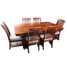 Solid Oak Dining Table and Chairs: A solid oak kitchen table and chairs. The six chairs feature slat backs with blue and white windowpane plaid seat cushions. The table comes with a removable leaf that is 12" wide.