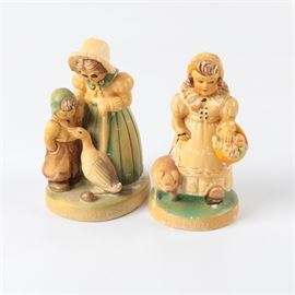 Chalkware Nursery Rhyme Figurines: A pair of chalkware figurines of nursery rhyme figurines. One depicts a woman and child with a goose and the other depicts a girl with a pig. Both are marked to the base.