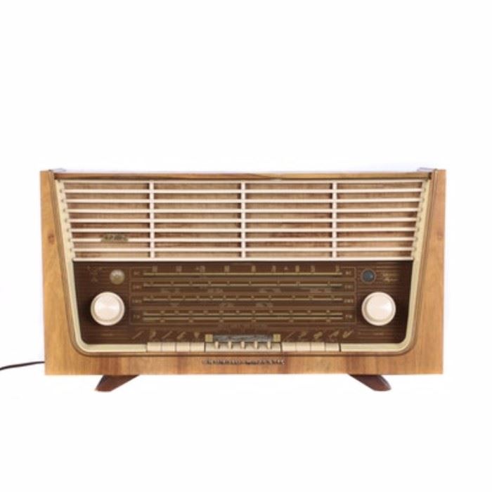 Grundig Majestic Broadcast Receiver: A vintage Grundig Majestic model 4085 USA broadcast receiver. This features thirteen FM circuits, eight AM circuits, and three loudspeakers. Grundig made this receiver in 1956/1957. It also features a lightly stained wooden body.