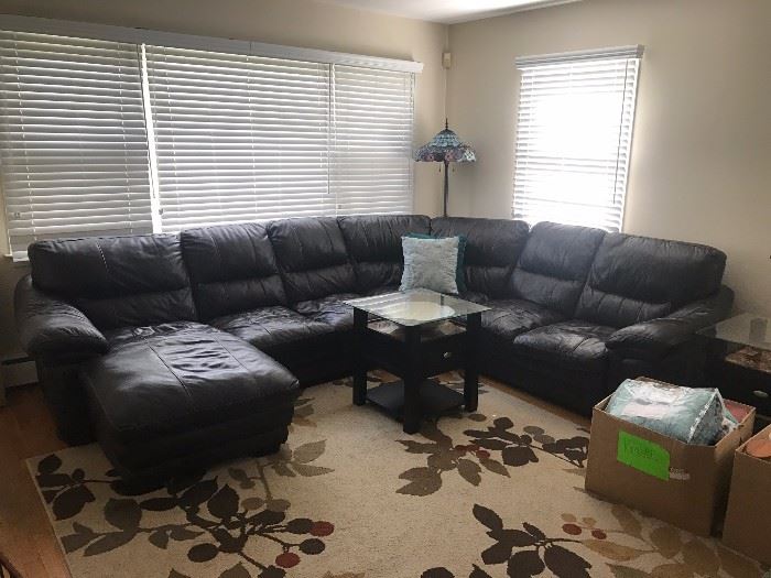 Bob's Sectional Leather Couch - $650     /    the long end to the center of the middle curved section is 9 feet, the short end to the center is 6 feet. The depth is 3 1/2 feet. The chaise is 5 1/2. The height is 3 feet 2 inches.  