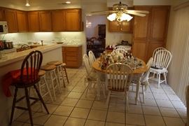 Family room table with six chair, stools, and little decoratives