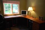 L -shape desk with spacious work area and file cabinets.