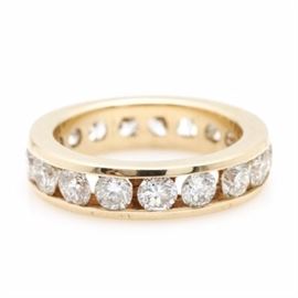 14K Yellow Gold 2.50 CTW Diamond Ring: A 14K yellow gold 2.50 ctw diamond eternity ring. This eternity ring features nineteen tension set diamonds channeling a highly polished band.
