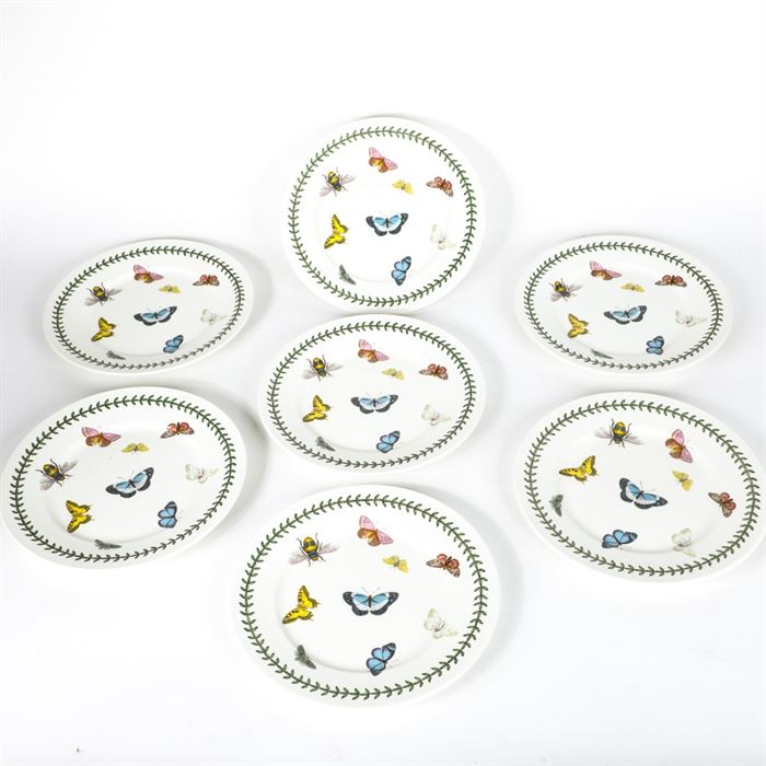 Portmeirion "Botanic Garden" Butterfly Plates: A collection of seven Portmeiron Botanic Garden butterfly plates. The white plates are decorated with bees and butterflies surrounded by a green laurel leaf border and are designed by Susan Williams-Ellis. They are marked on the reverse.