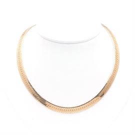 14K Yellow Gold Herringbone Chain Necklace: A 14K yellow gold herringbone chain necklace.