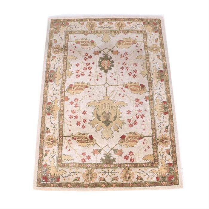 Persian Style Machine Woven Wool Area Rug: A machine-woven wool area rug. The design features an open arrangement of herati worked in shades of green, saffron, buff, tan, rust, and faded red on an off-white field. The compound borders of stylized flowers and foliage combine with palmettes in the same palette. There is no fringe. The number 061840-19 has been written in black ink on the back of the rug.