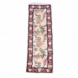 Hand Tufted Chinese Carved Wool Runner: A hand tufted Chinese carved wool runner. This rug features an ivory field with all-over floral motifs, bordered in red with coordinating pattern, and bright blue guard borders. The floral patterns show colors in rose, cream, and sage green. The backing shows a tag that reads, “G.A. Gertmenian & Sons, Made in China”.