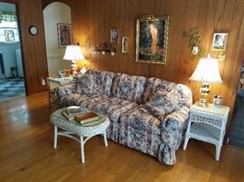 Floral Sofa that has a Love Seat to Match. Wicker end tables and coffee table 