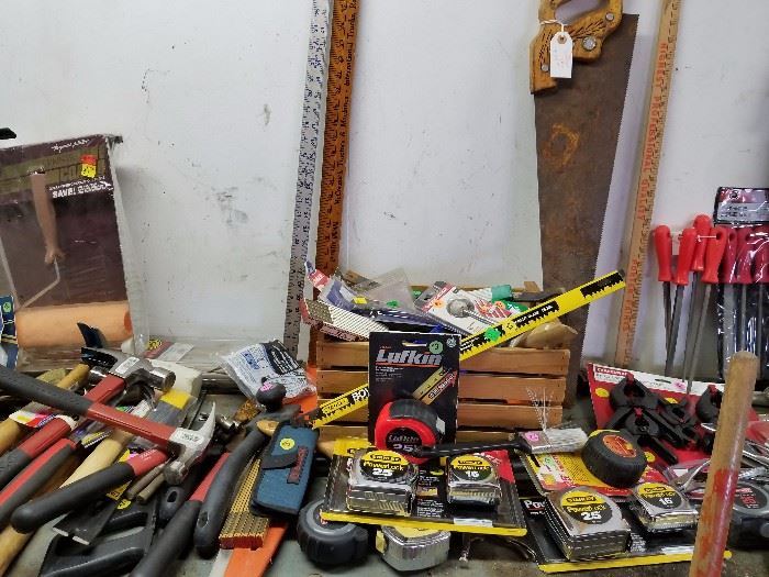 Various vintage small tools. Yardsticks, steel measuring tapes, hammers, paint scrapers, more.
