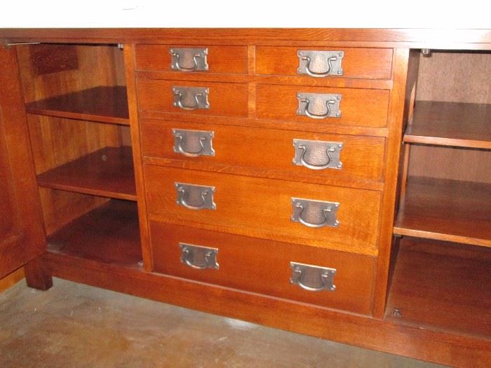 Mission Collection
Syracuse Sideboard
Derived from the sideboard that once graced Gustav Stickley’s home in Syracuse, New York, this impressive Mission sideboard includes two cupboard doors fitted with two adjustable shelves behind each. Four small drawers and three graduated drawers line the center of the piece with a Pacific Silvercloth® liner located in the third drawer down from the top. 
