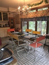 Fantastic 6 iron director chairs and glass top table overlooking the backyard! Tall Display cabinet and pottery chandelier! 