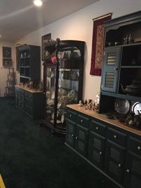 Second Heywood-Wakefield hutch and cabinet filled with figurines, brass items, and more silverplate! Magnificent oak large curved glass antique cabinet displays porcelain plates, Snowbabies and kewpies, and shell fancies!