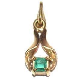 14K Gold Emerald Necklace Pendant: An 14K yellow gold necklace pendant with a classic emerald cut emerald.
