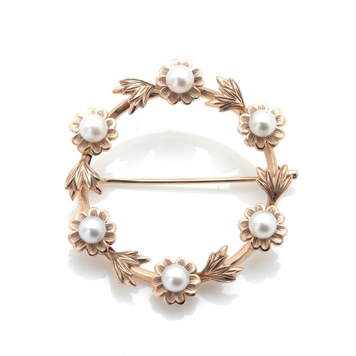 Mikimoto 14K Yellow Gold Pearl Wreath Brooch: A Mikimoto 14K yellow gold pearl wreath brooch featuring six cultured pearls accenting a floral wreath design with mill grain trimming.