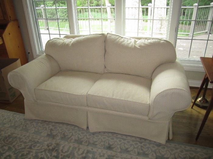 There are two matching 2 seater couches, that have slip covers on them.  The original white upholstery has never been sat on, so they are like new