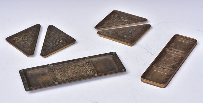 Tiffany Studios Bronze Desk Set Pieces
including two pen trays,
Graduate and 9th Century patterns,
and four blotter corners, Abalone pattern
early 20th century
