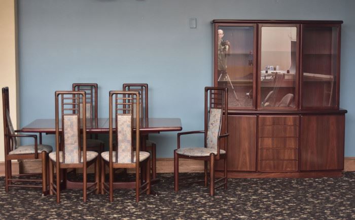 Danish Modern Dining Room Set
consisting of Skovby breakfront china
cabinet 65" x 16 1/2" x 73" high, a Skovby
dining table, 39" x 65", 28" high, two leaves
each 19 3/4" wide, a set of six Kvist chairs
each 43" high
circa 1970