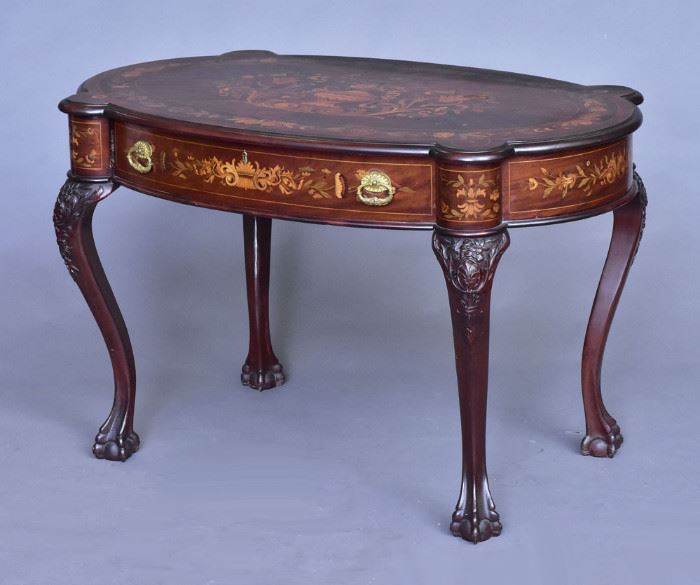 Victorian Marquetry Library Table
attributed to R. J. Horner
inlaid with flowers and urn
carved knees and claw feet
47 1/2" x 26 1/2", 30" high
circa 1900