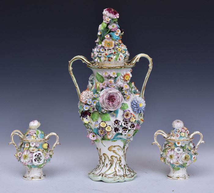 German Porcelain Potpourri
urn form with applied floral decoration
19" high together with two similar 
examples, each 6 1/2" high
early 20th century