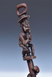 Folk Art Carved Walking Stick
with snake staff and carved figure of 
a man smoking a pipe
54" long, 20th century