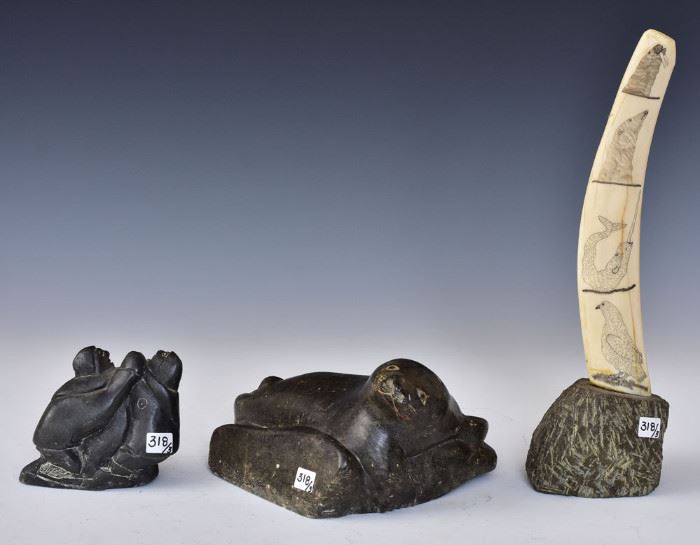 Inuit Art (3)
Reclining Seal, 9 1/2" long,
engraved walrus tooth, 15" high overall
and Hunters with Seal, 4 1/2" high,
signed George Alayco