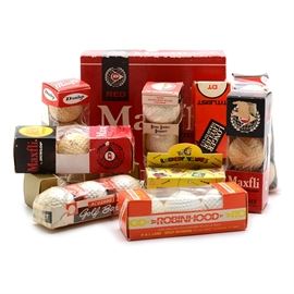Miscellaneous Golf Ball Packs: A selection of golf balls in their original packaging. There is a dozen “Maxfli by Dunlop Red” golf balls. There are ten pack of golf balls that have three balls in each package, they are: “Maxfli by Dunlop Red” (“New Improved” yellow sticker on the box); “Dunlop Super Maxfli”; “Maxfli by Dunlop Red”; “Dunlop Elite”; “RAM 3D Distance Durability Dependability High-Tension Wound Core”; “Titleist DT Longer Livelier Tough-To-Cut”; “Custom Designed Golf Balls”; “Acushnet”, “Titleist Les Copeland” is on the balls; and “Robinhood The Longest Ball in Golf!”. There is a two pack of golf balls that feature “Looney Tunes” characters, one has Bugs Bunny, the other has the Tasmanian Devil.