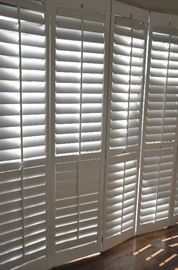 White wooden 3.5" plantation shutters for sale throughout the home!