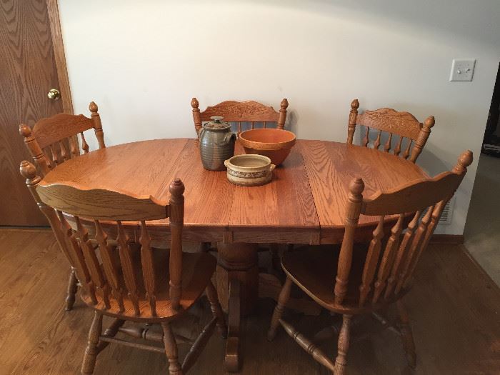 Beautiful condition.  Solid Oak pedestal table with leaf in and chairs. 