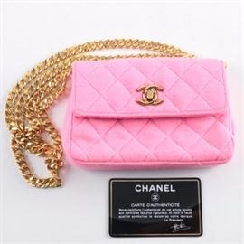 Chanel Pink Quilted Jersey Mini Flap Bag: A Chanel pink quilted jersey mini flap bag. The bag features the iconic gold-tone double “C” latch on the flap and a gold-tone double should chain. The bag features an interior compartment with a gold-tone stamped “Chanel” logo and serial number “0235343”. The bag comes with an authenticity card.