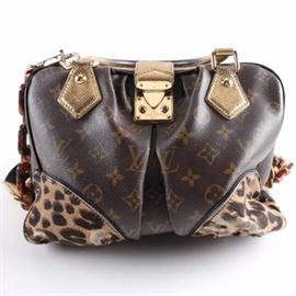 2006 Louis Vuitton Limited Edition Adele Handbag: A 2006 Louis Vuitton Limited Edition Adele handbag. The handbag features dual handles and trim of karunf leather dyed metallic gold, with a shoulder strap comprised of black canvas, faux tortoise shell resin chain links, a black patent leather shoulder pad and branded brass d-rings. The body of bag is monogrammed coated canvas with a single inverted box pleat, corner guards of leopard print pony hair with a zippered top opening and a branded tab lock closure. A black Alcantara lining with a side slip pocket, leather brand emblem, and embossed date code of TH0096 complete the design.