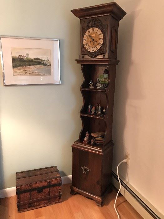 Vintage clock with nicknack shelves and lower cabinet.