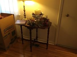 Oval vintage table with decor and lamp